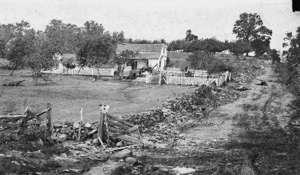 The Lydia Leister house at Gettysburg, which Meade used as his headquarters during the battle. Notice the dead horses in the road. Lyman relates a story about Meade here on July 3, 1863 (Library of Congress).