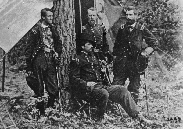 In this image taken at Cold Harbor in 1864, Winfield Scott Hancock (seated) poses with (left to right) Francis Barlow, David Birney, and John Gibbon (Library of Congress). 