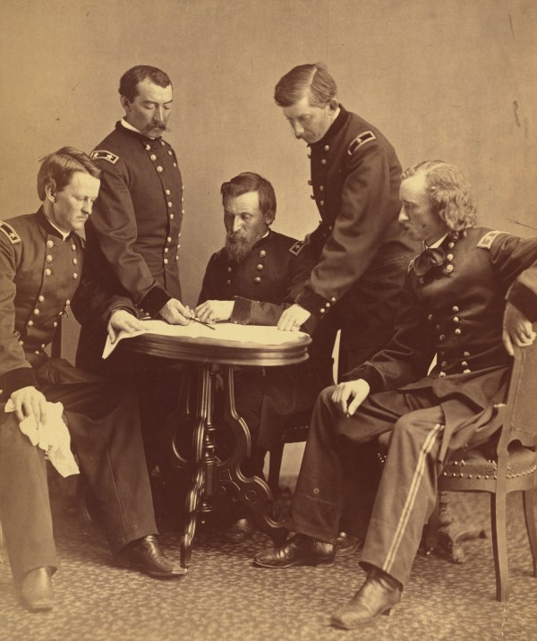 "Photograph showing Generals Wesley Merritt, Philip Sheridan, George Crook, James William Forsyth, and George Armstrong Custer around a table examining a document." Click to enlarge (Library of Congress).