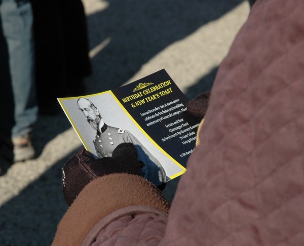 A visitor holds a brochure about the 2014 event (Tom Huntington photo).